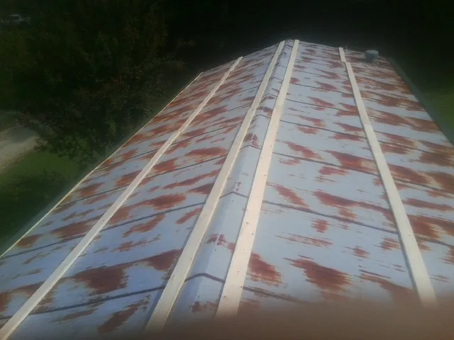 Rusted metal roof panels with new wood purlins before replacement — Storm Damage Roof Repair in Hamilton by Roofing Brothers